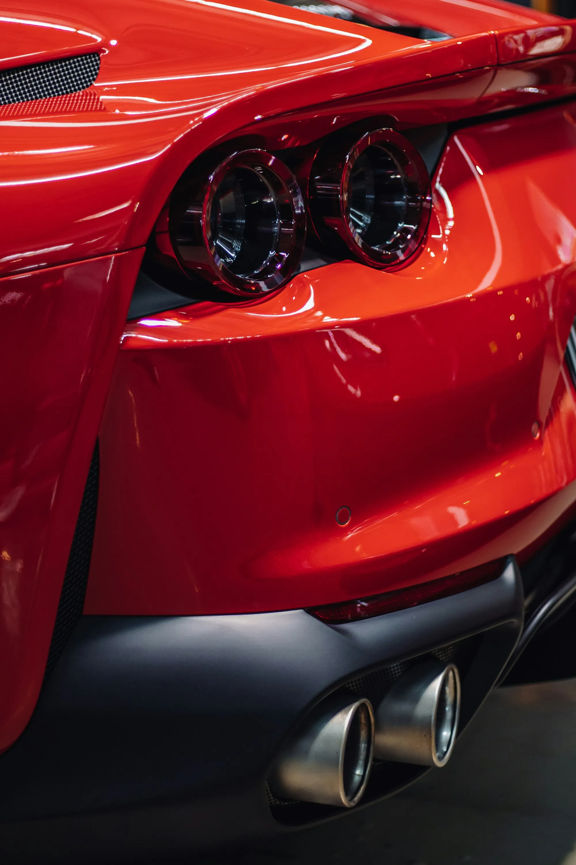 Rear quarter panel and taillight of a red sports car